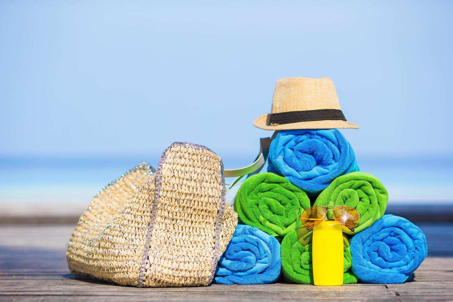 Stacked towels and beach accessories photo