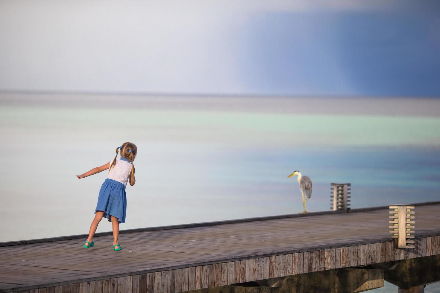Girl running on a dock photo