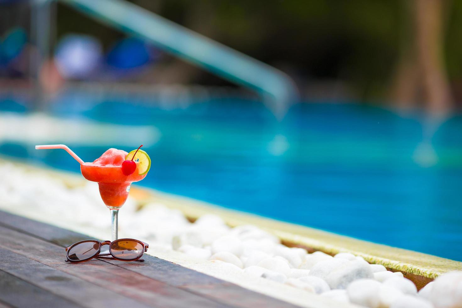 Red cocktail at a swimming pool photo