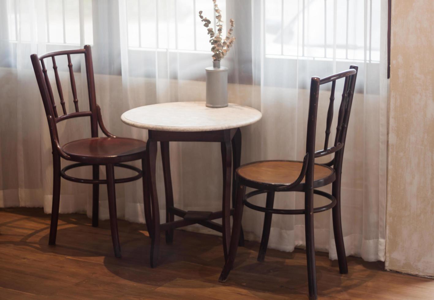 Table and chairs in a coffee shop photo