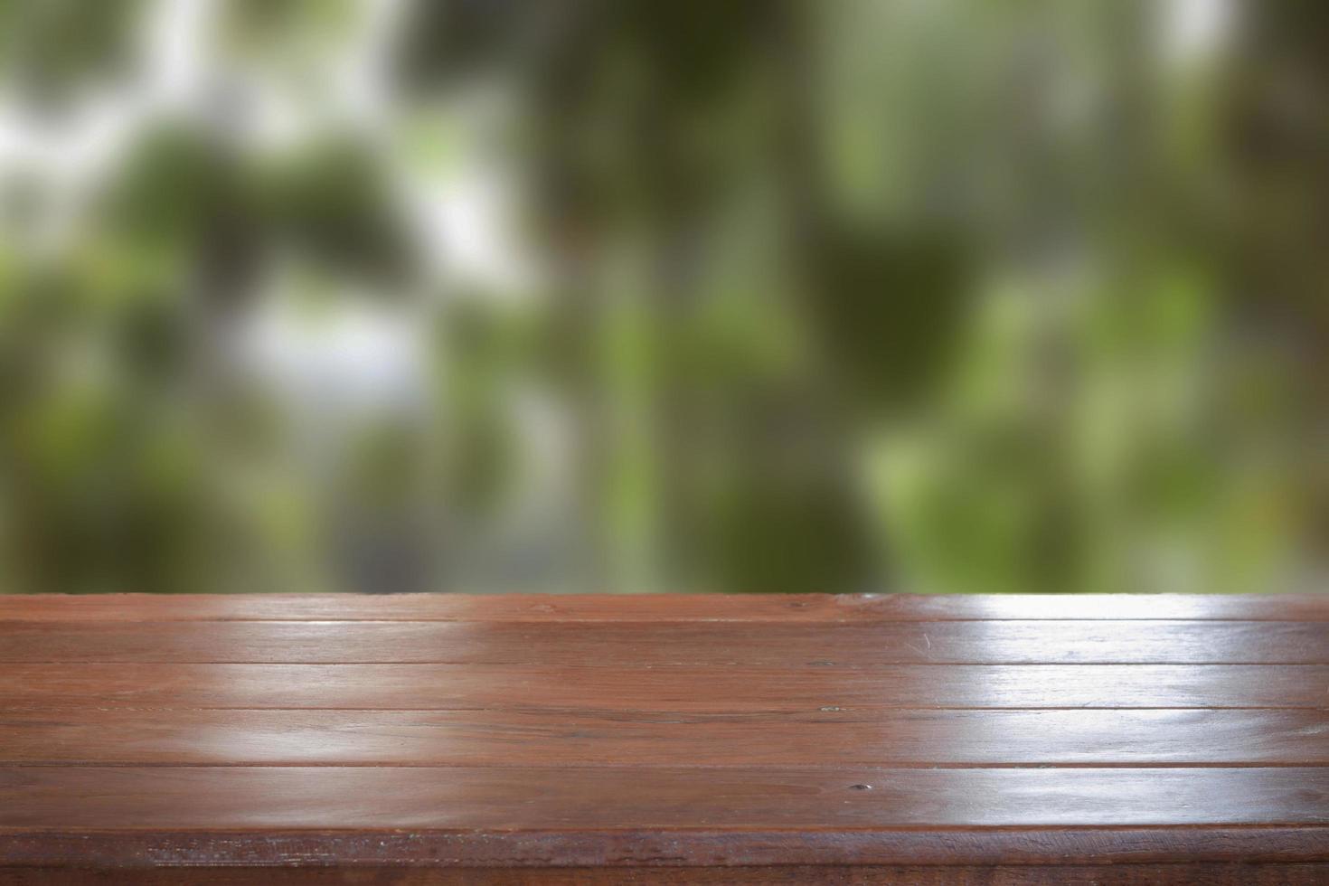 Old empty wooden table top with blurred background photo