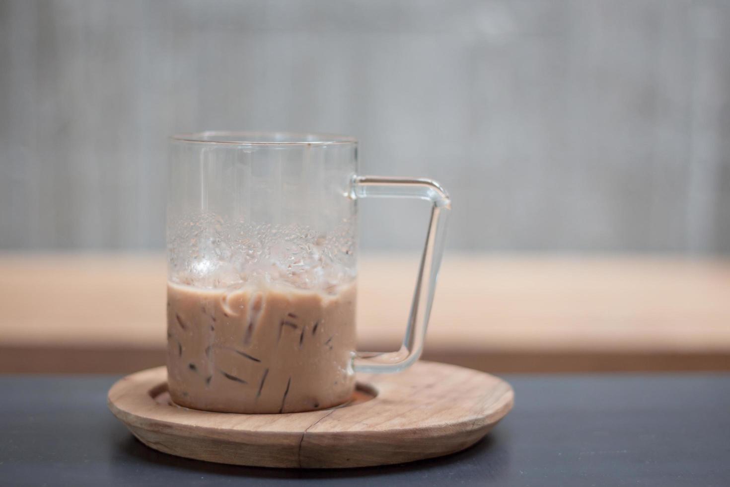 Iced coffee on a wooden lid photo