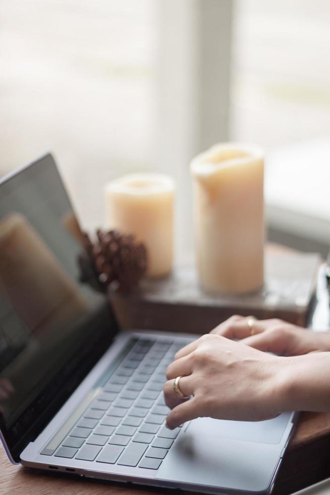 Close-up of a person working at a laptop photo