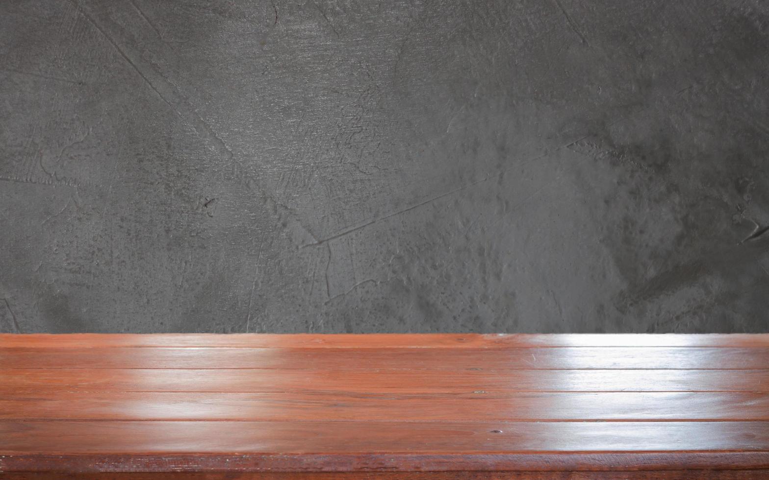 Wooden table against a dark grey background photo