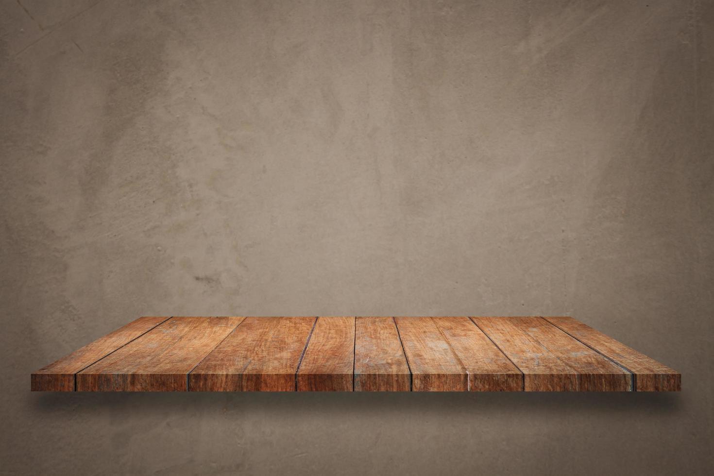 Wooden shelf on concrete background photo