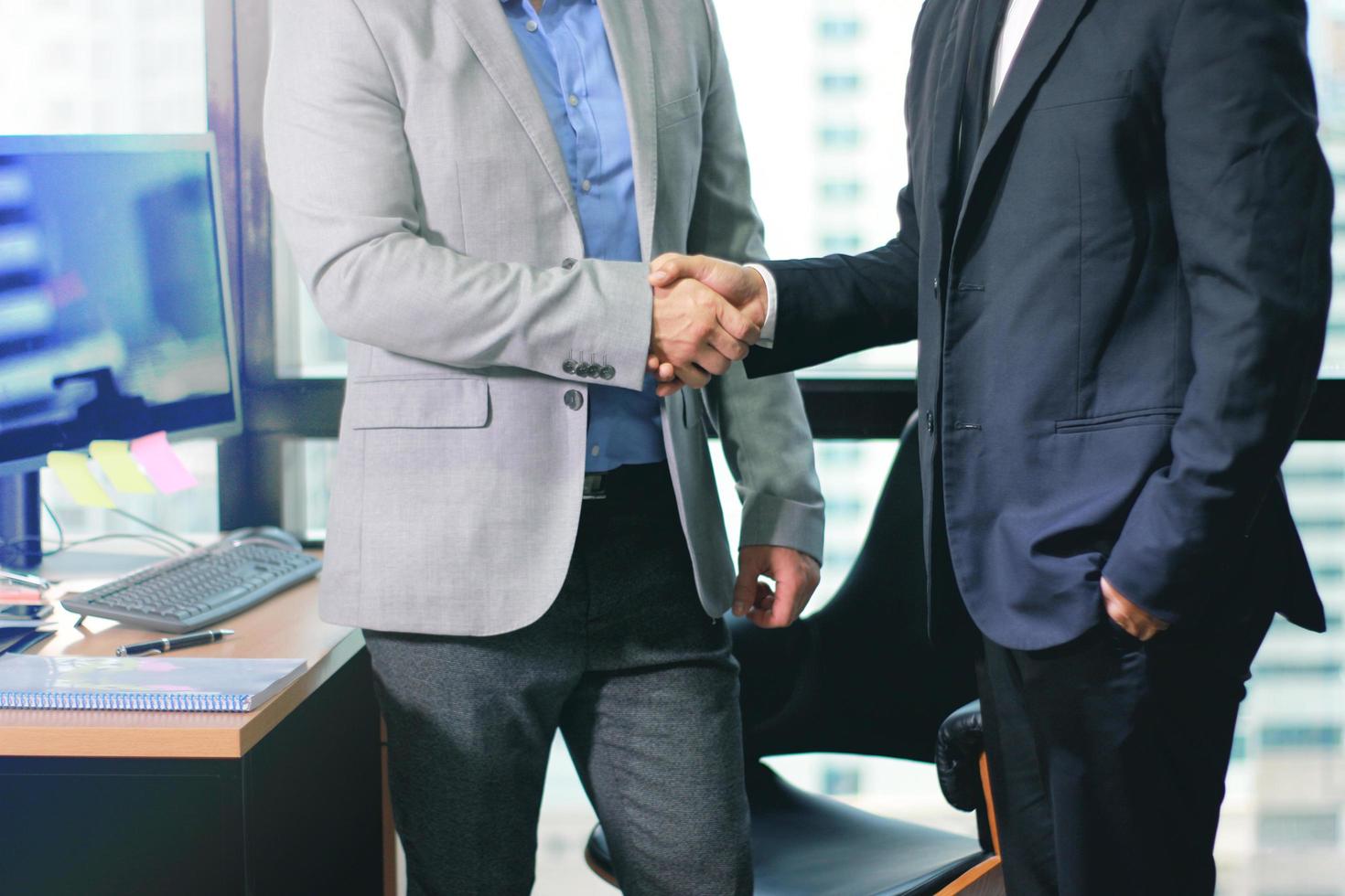 Businessmen making handshake in the office photo