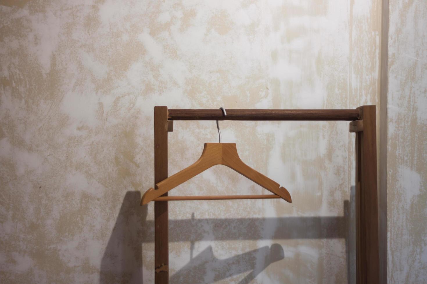 Wooden hanger on beige wall photo