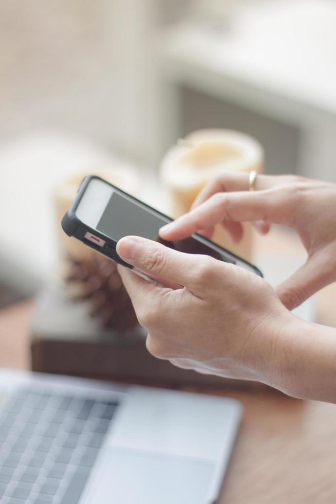 Woman using smartphone in coffee shop photo