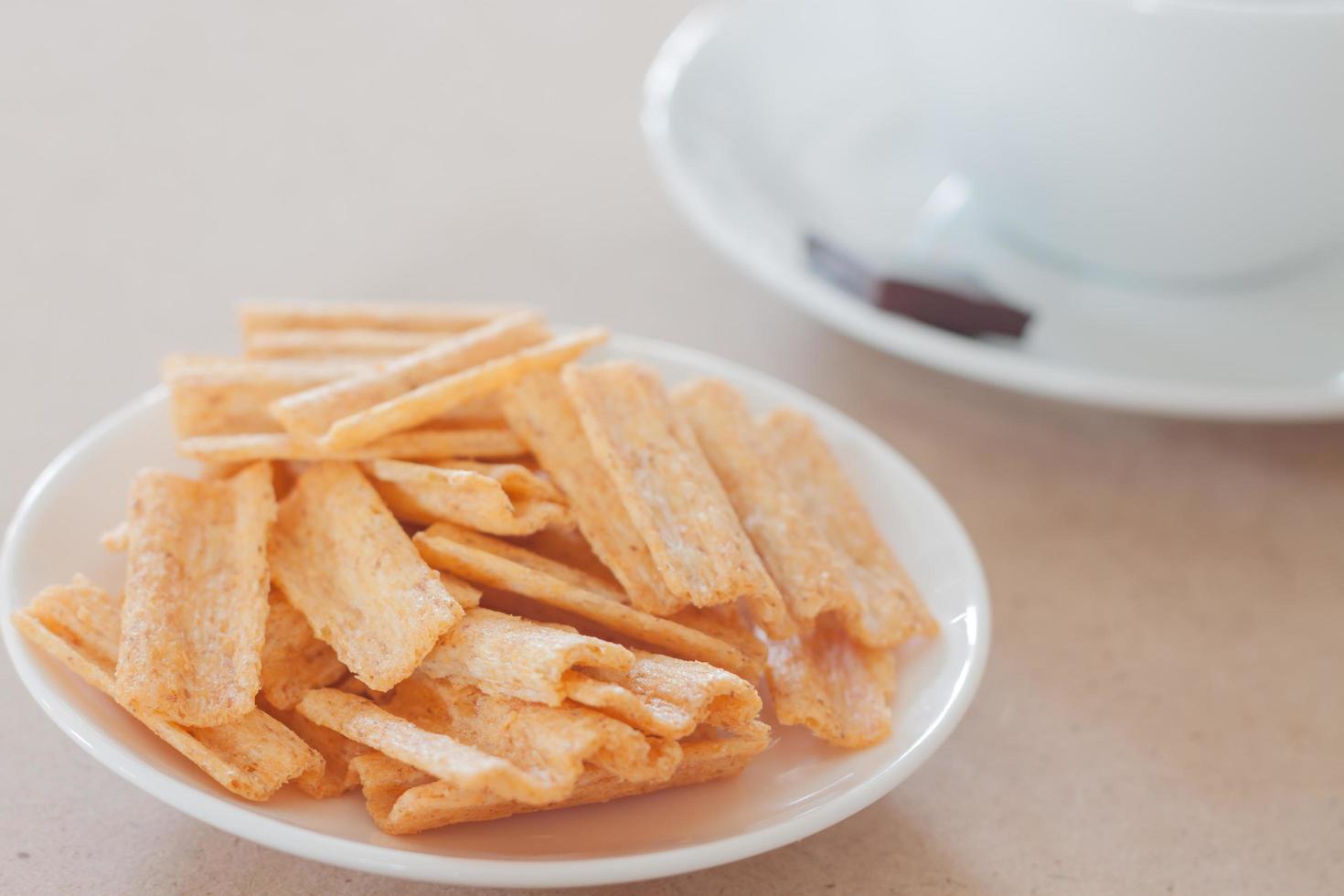 Snack on a plate with a coffee cup photo