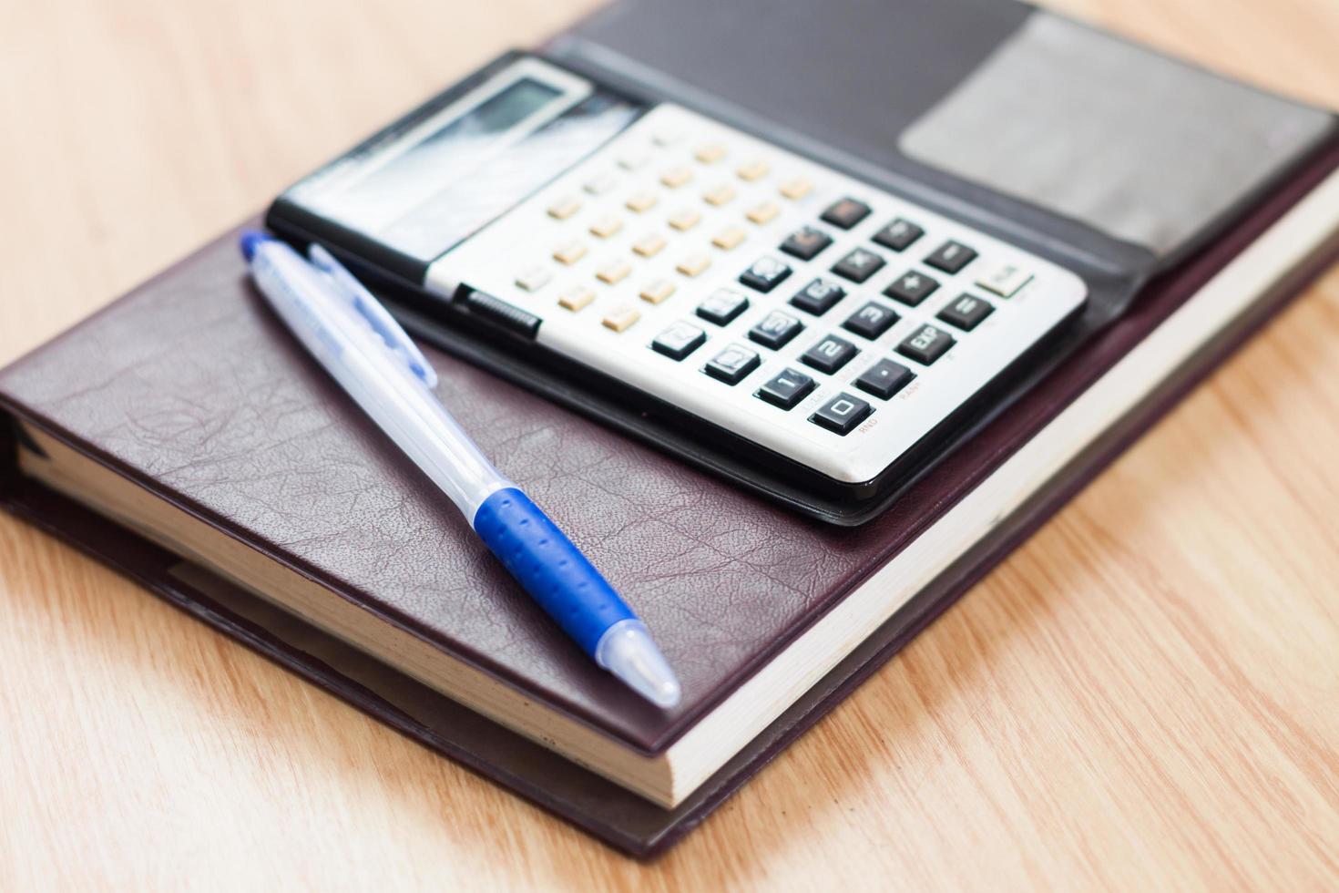 Calculator and pen on a notebook photo