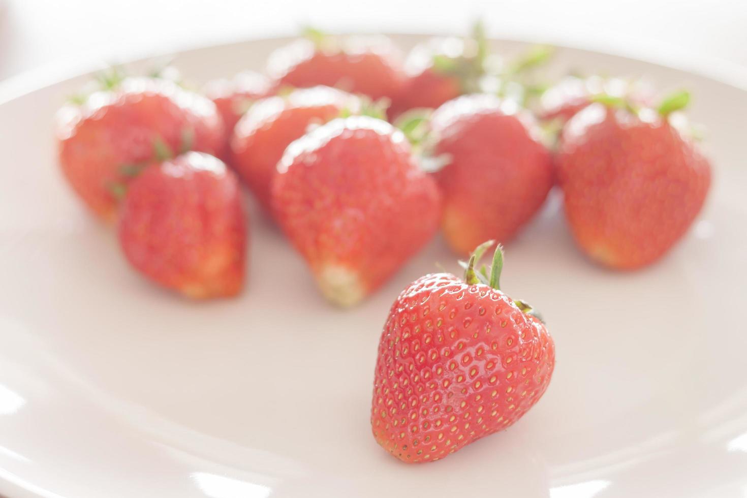 Strawberries on a white plate photo