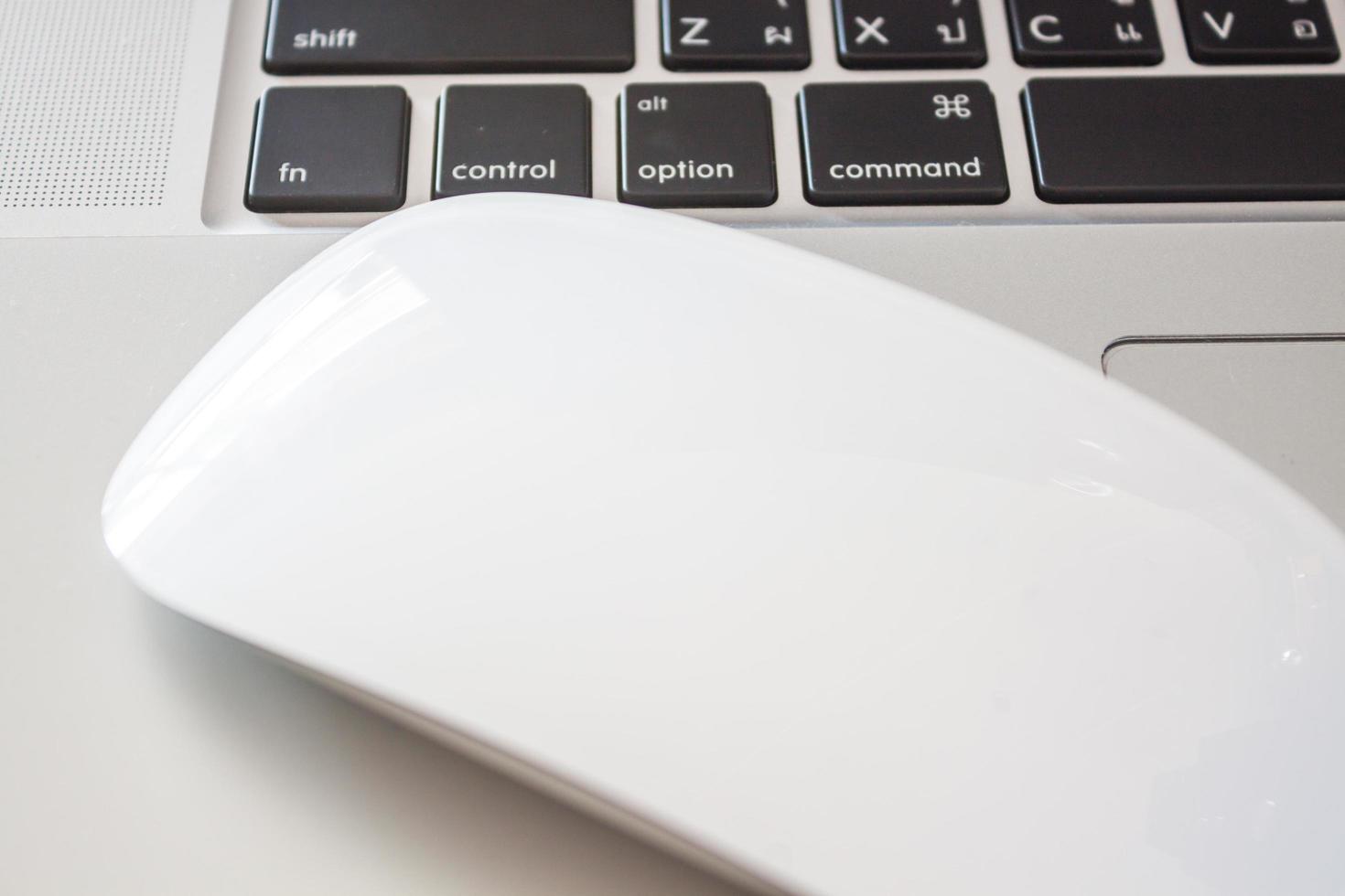 Close-up of a mouse and a laptop photo