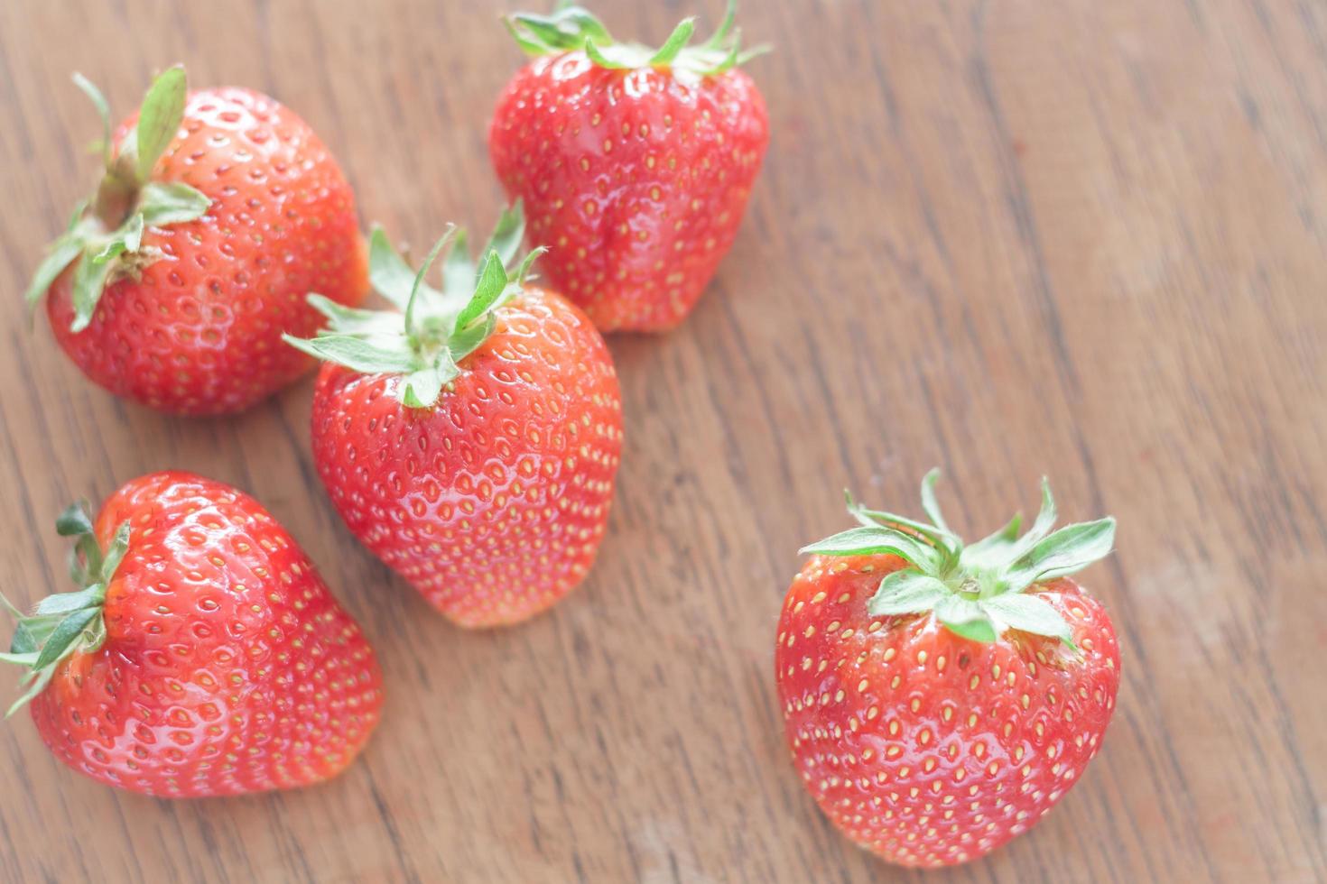 Strawberries on a wooden table photo