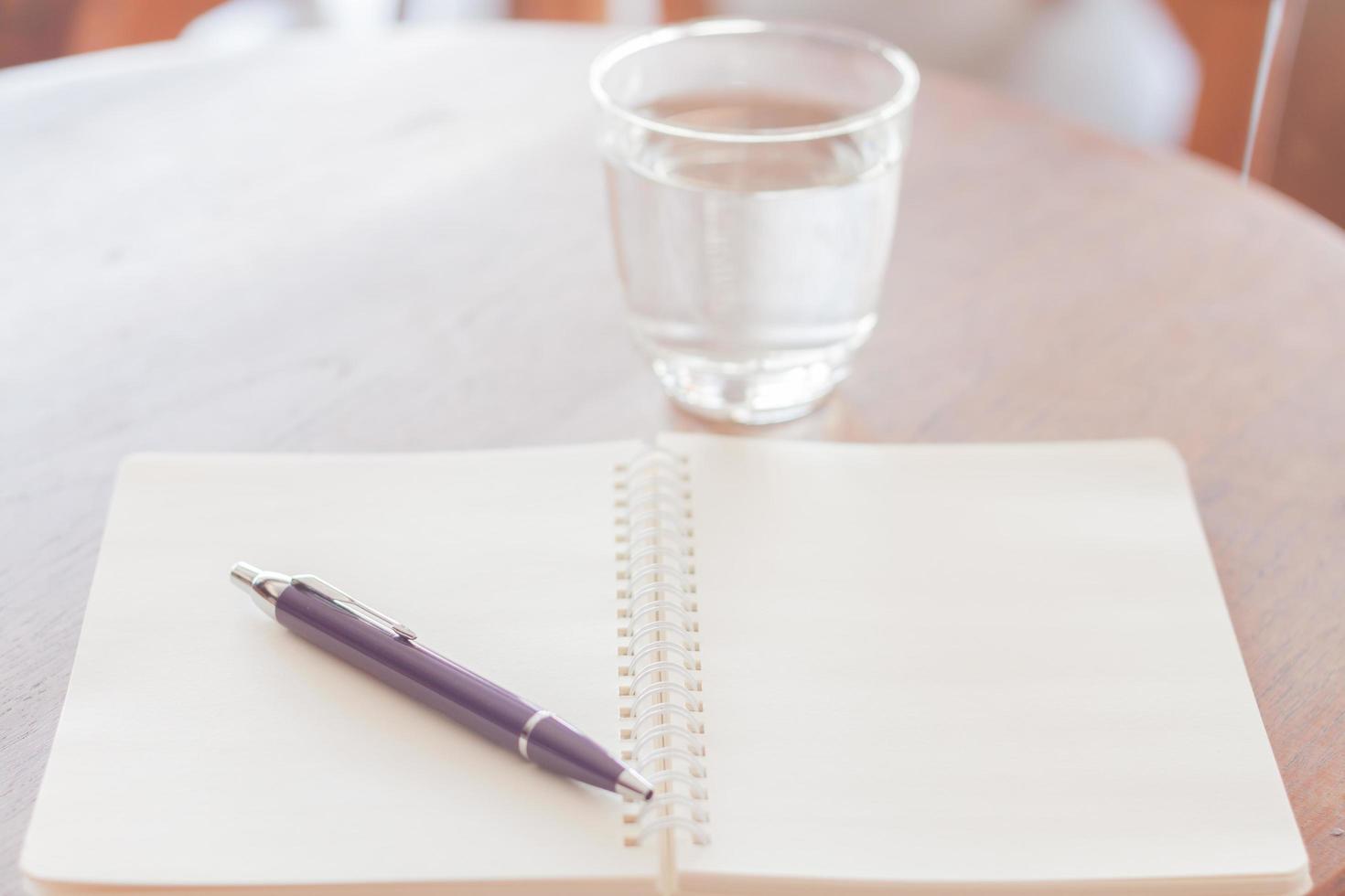 Open notebook and pen with water photo
