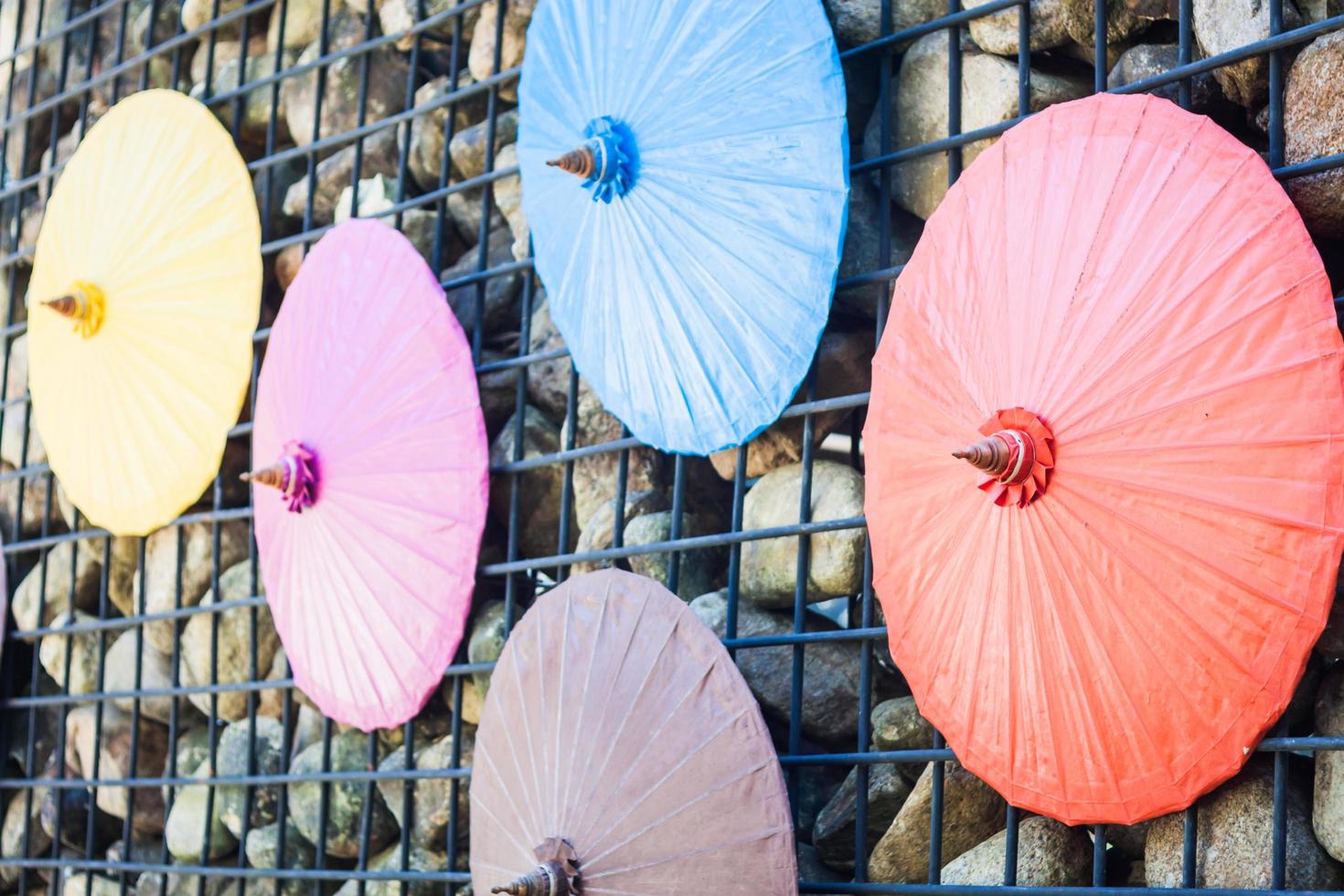 Colorful umbrellas on a wall photo