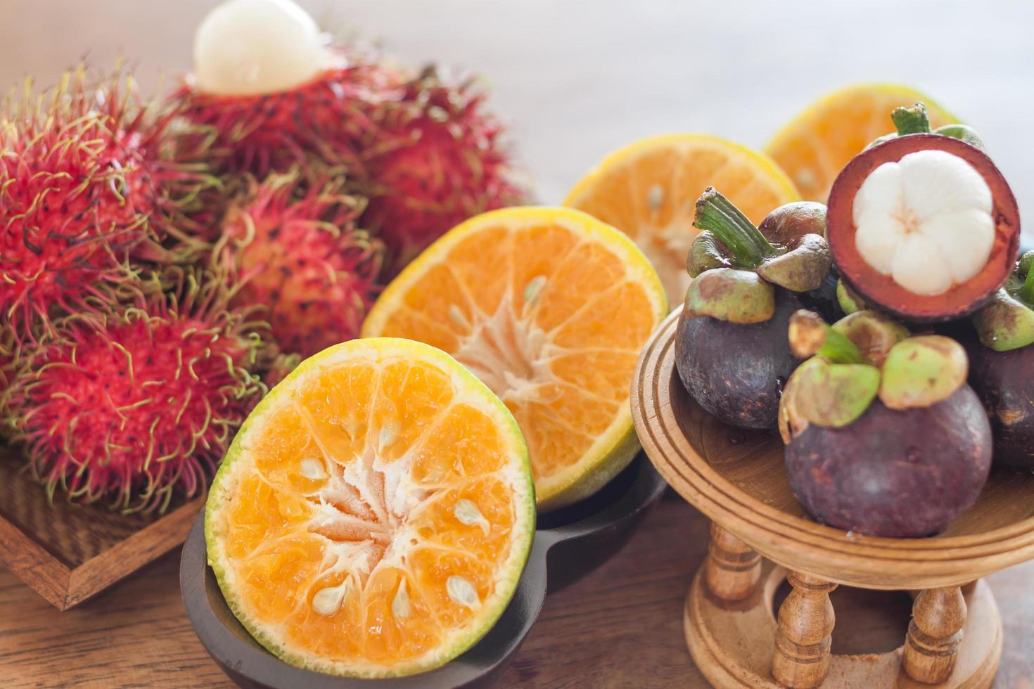 Tropical fruit on a wooden table photo