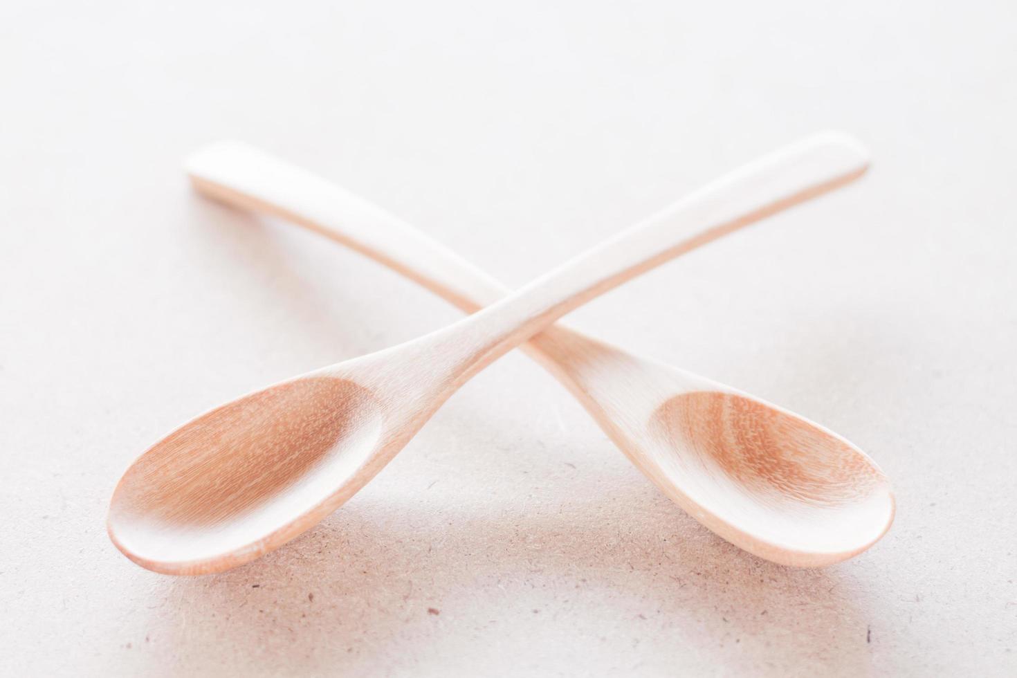 Empty spoons crossing on a white background photo
