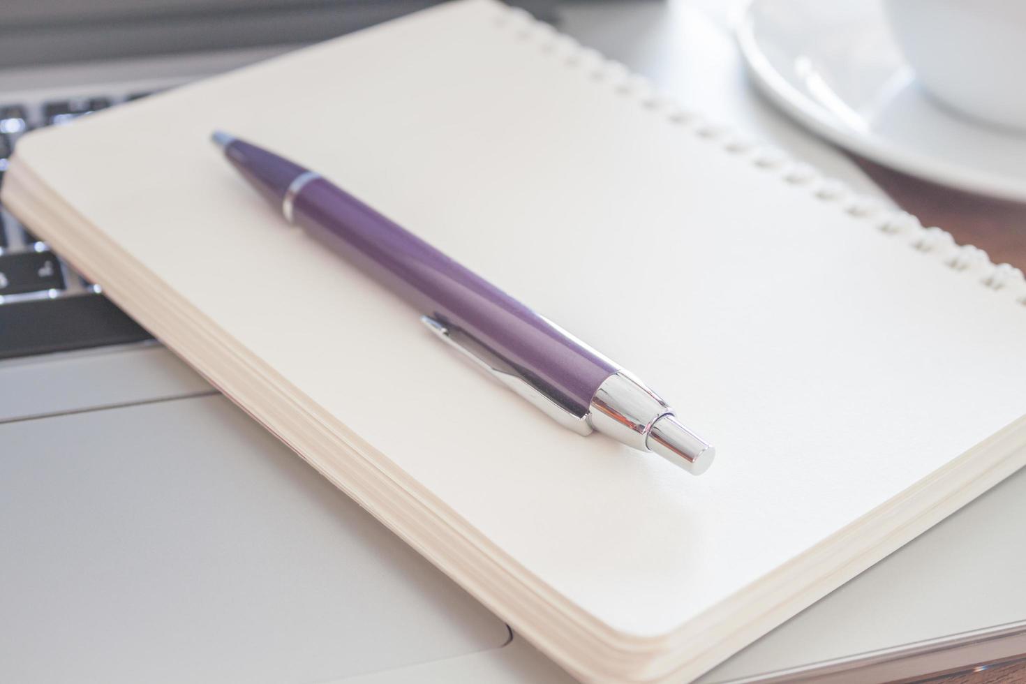 Close-up of a notebook with a pen photo