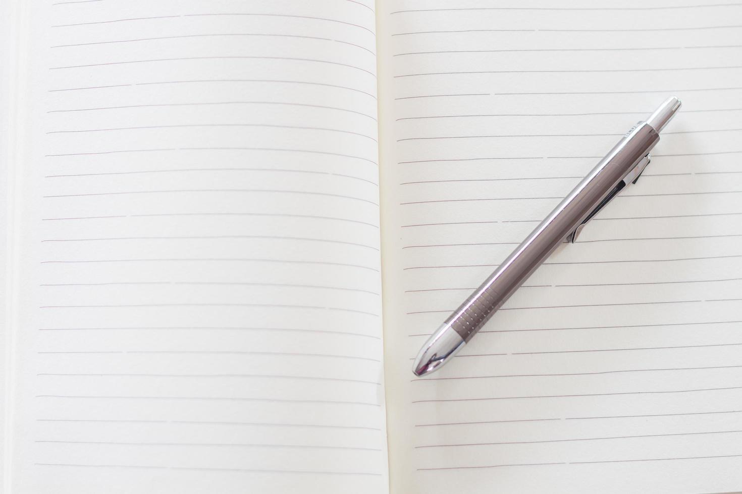 Close-up of a notebook and pen photo