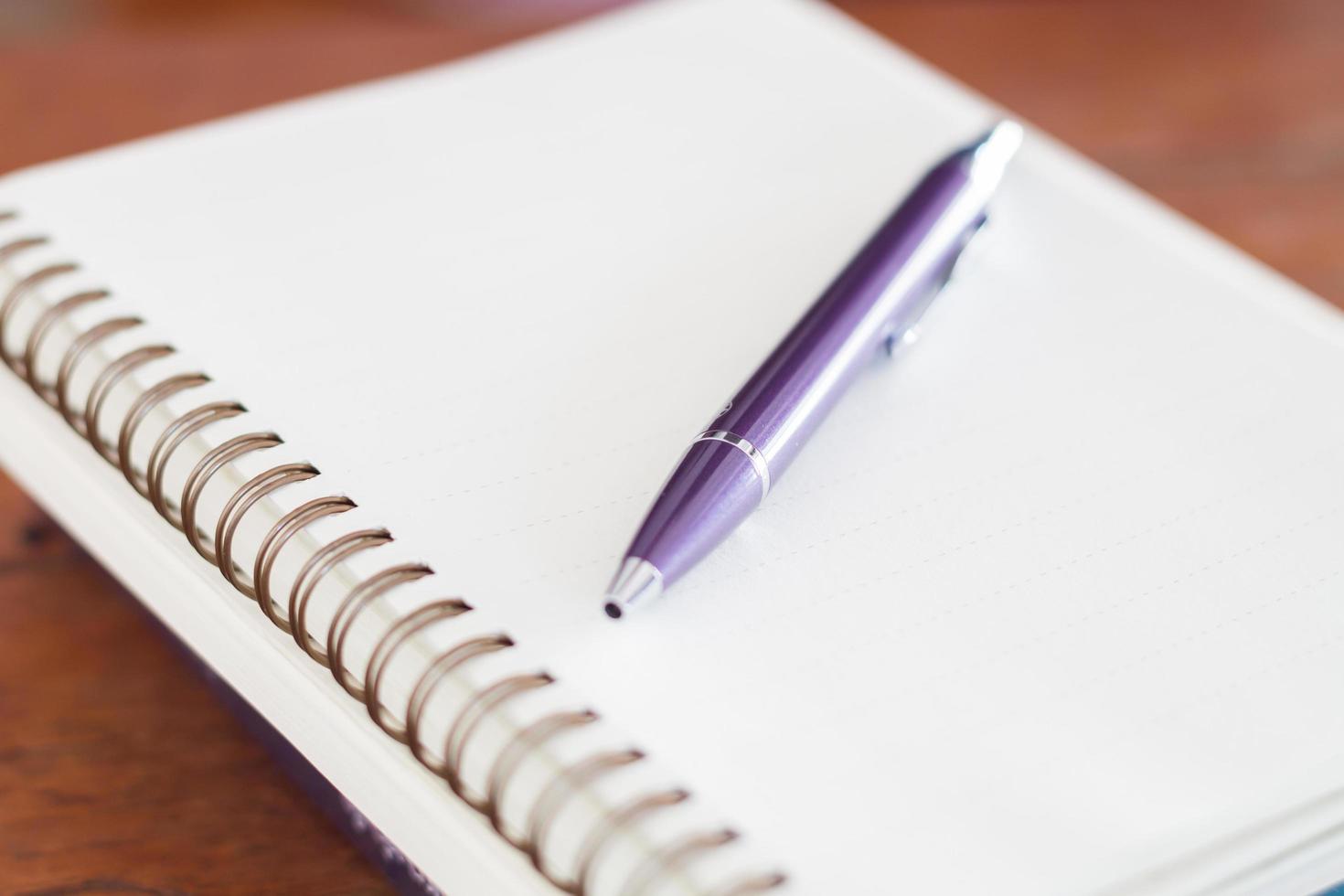 Purple pen and a spiral notebook photo