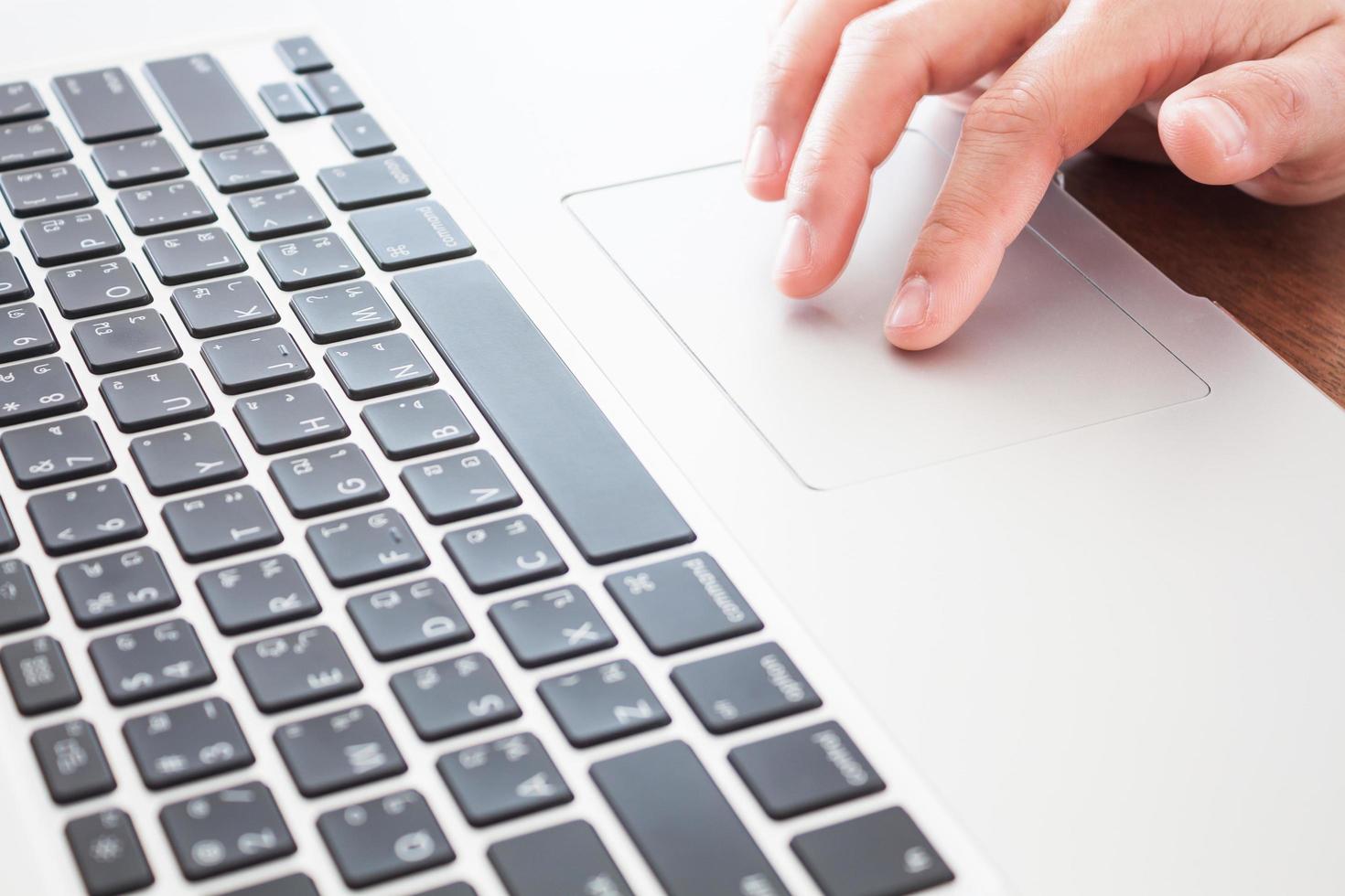 Close-up of a person using a trackpad photo