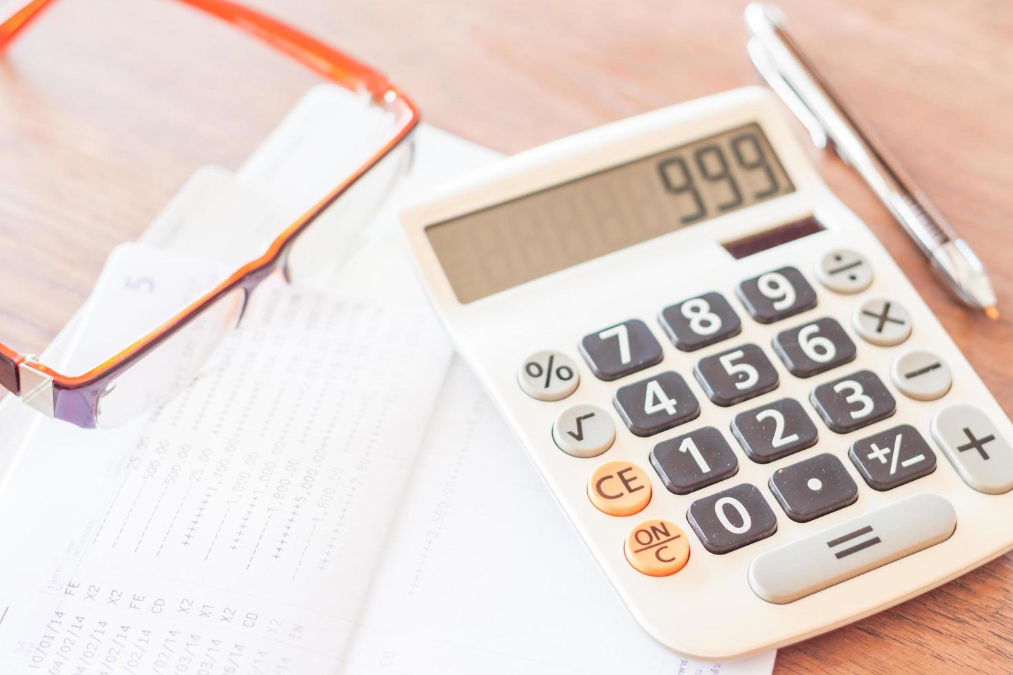 Bank account passbook with a pen, calculator and eyeglasses photo