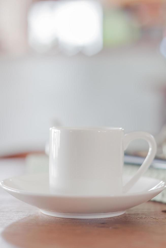 Mini white coffee cup in a coffee shop photo