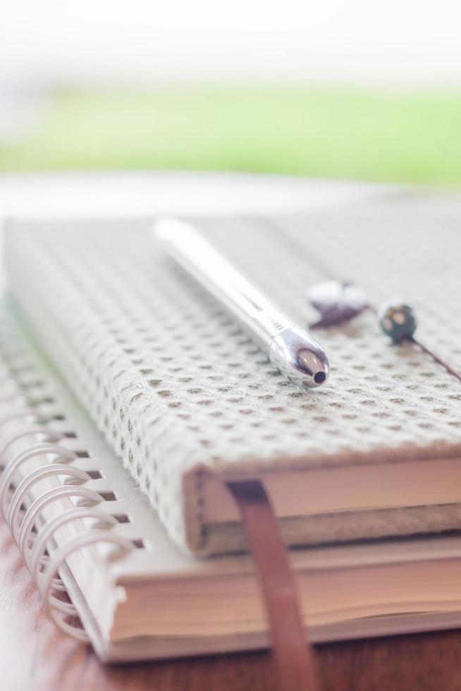 Close-up of a pen on two notebooks photo