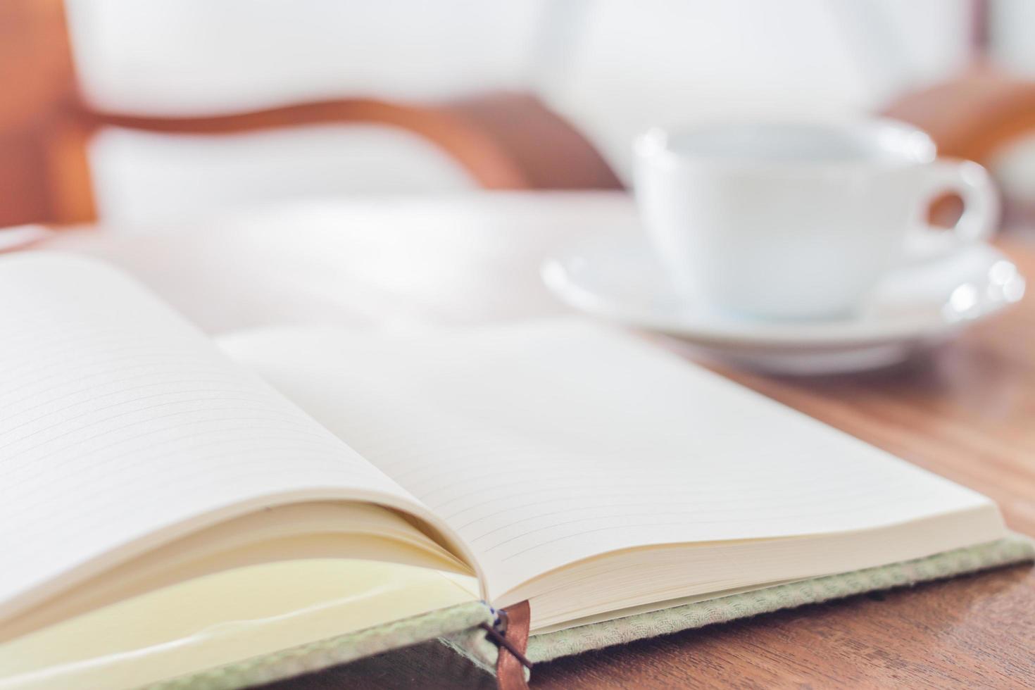 Notebook and a coffee on a table photo