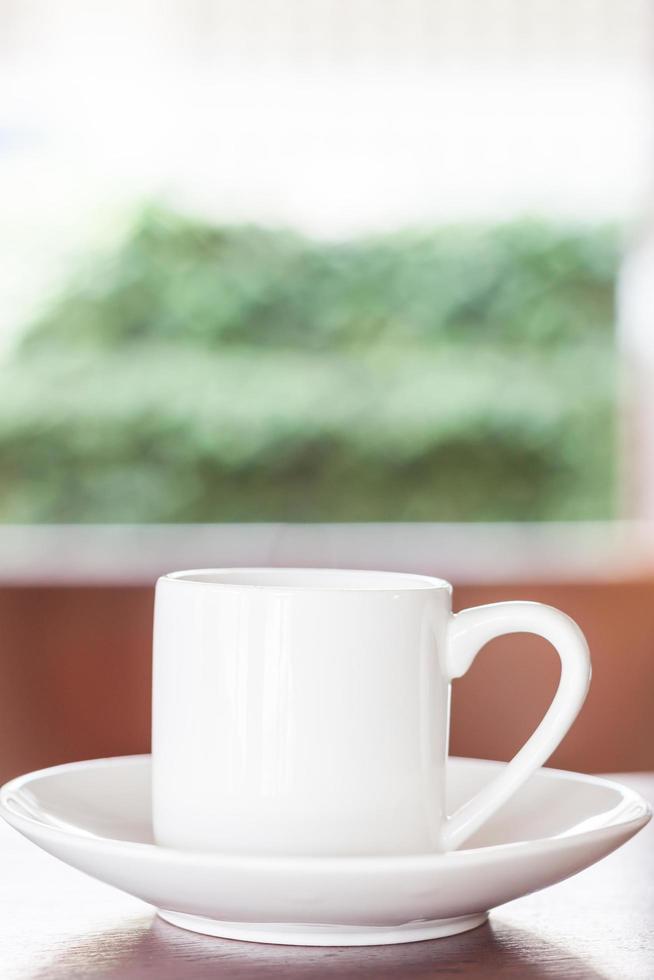 White cup on table photo