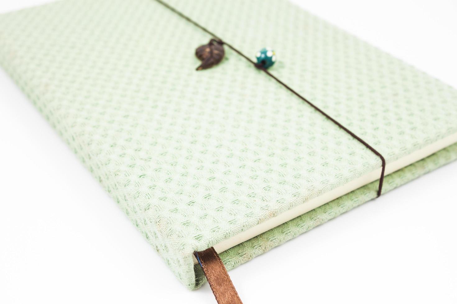 Green notebook on a white background photo