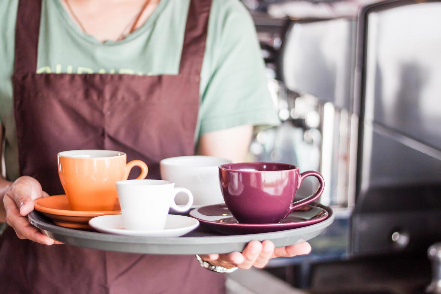 Server holding a tray of coffee photo