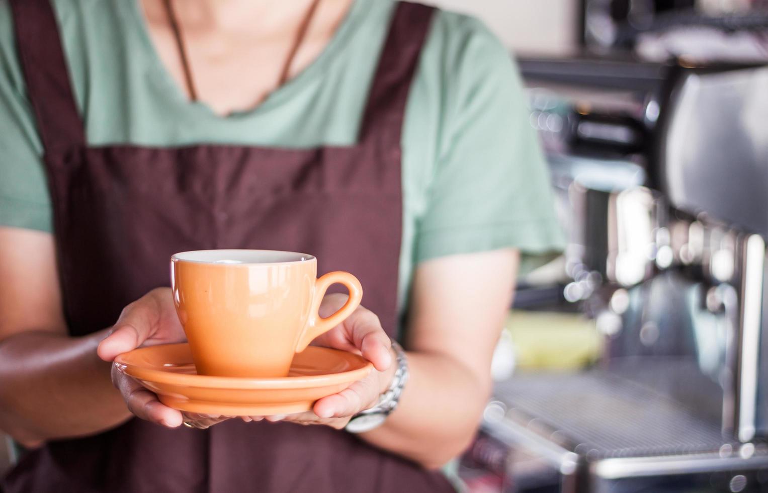 Barista presents freshly brewed coffee photo