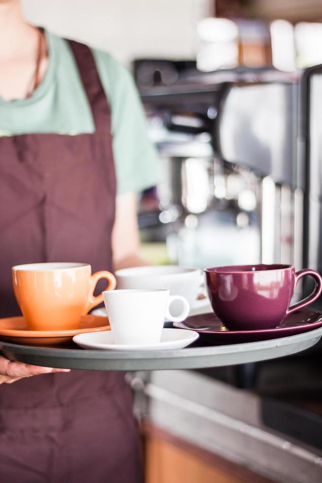 barista sosteniendo una bandeja de café foto