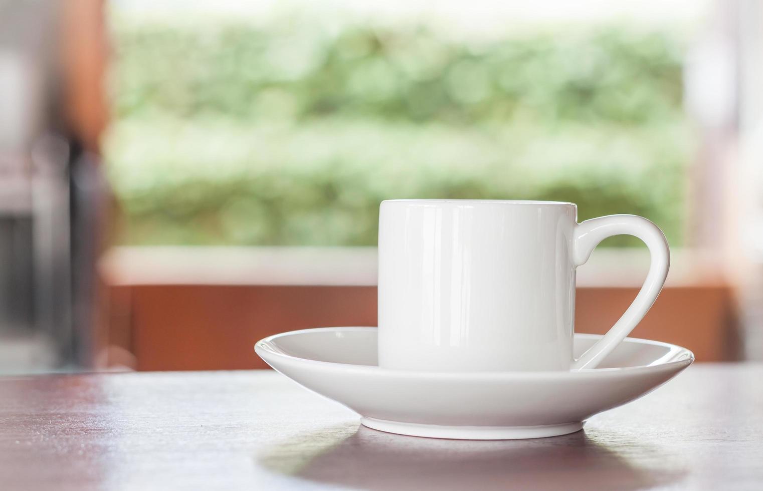 White cup on a table photo