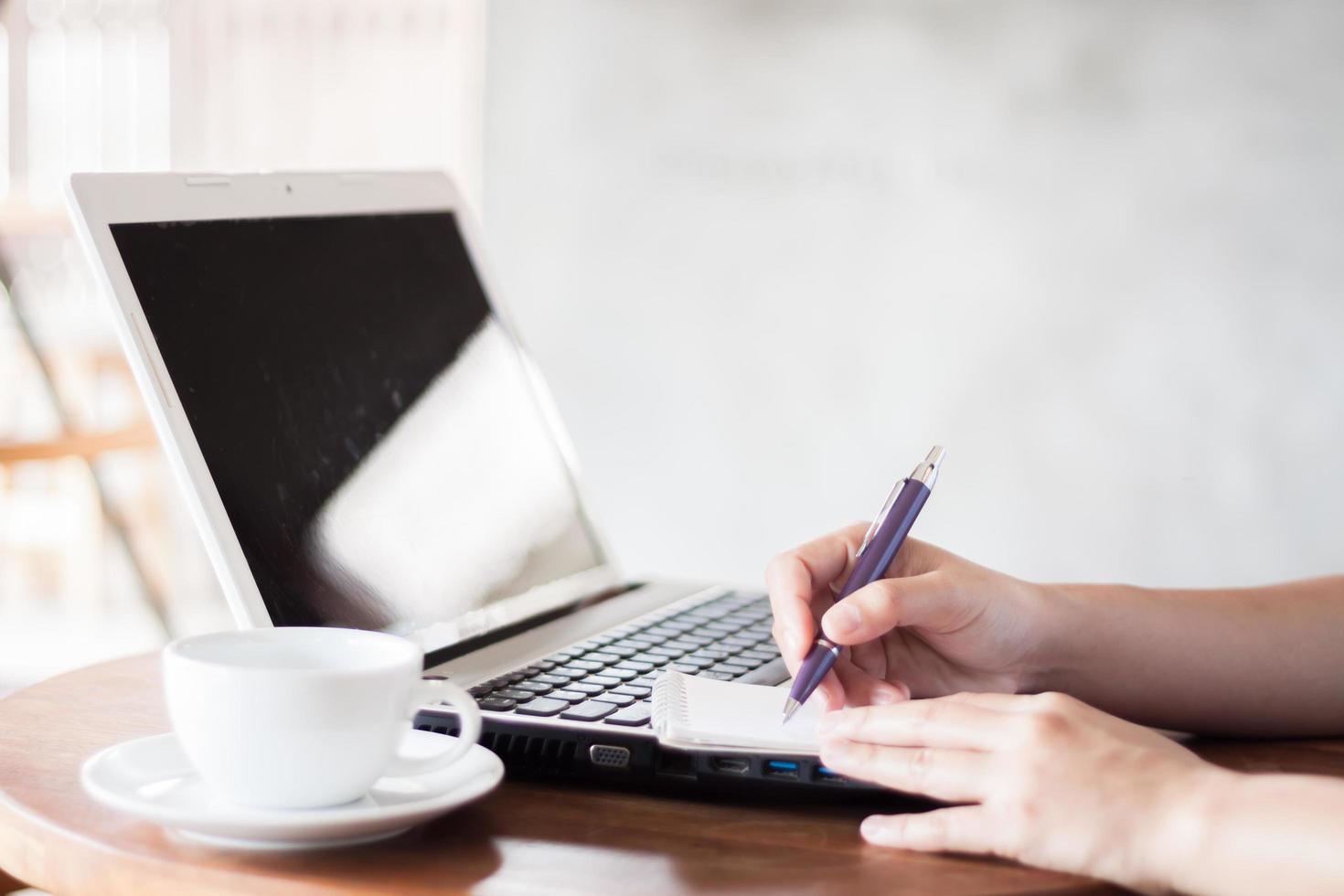 Close-up of a woman working in a coffee shop photo