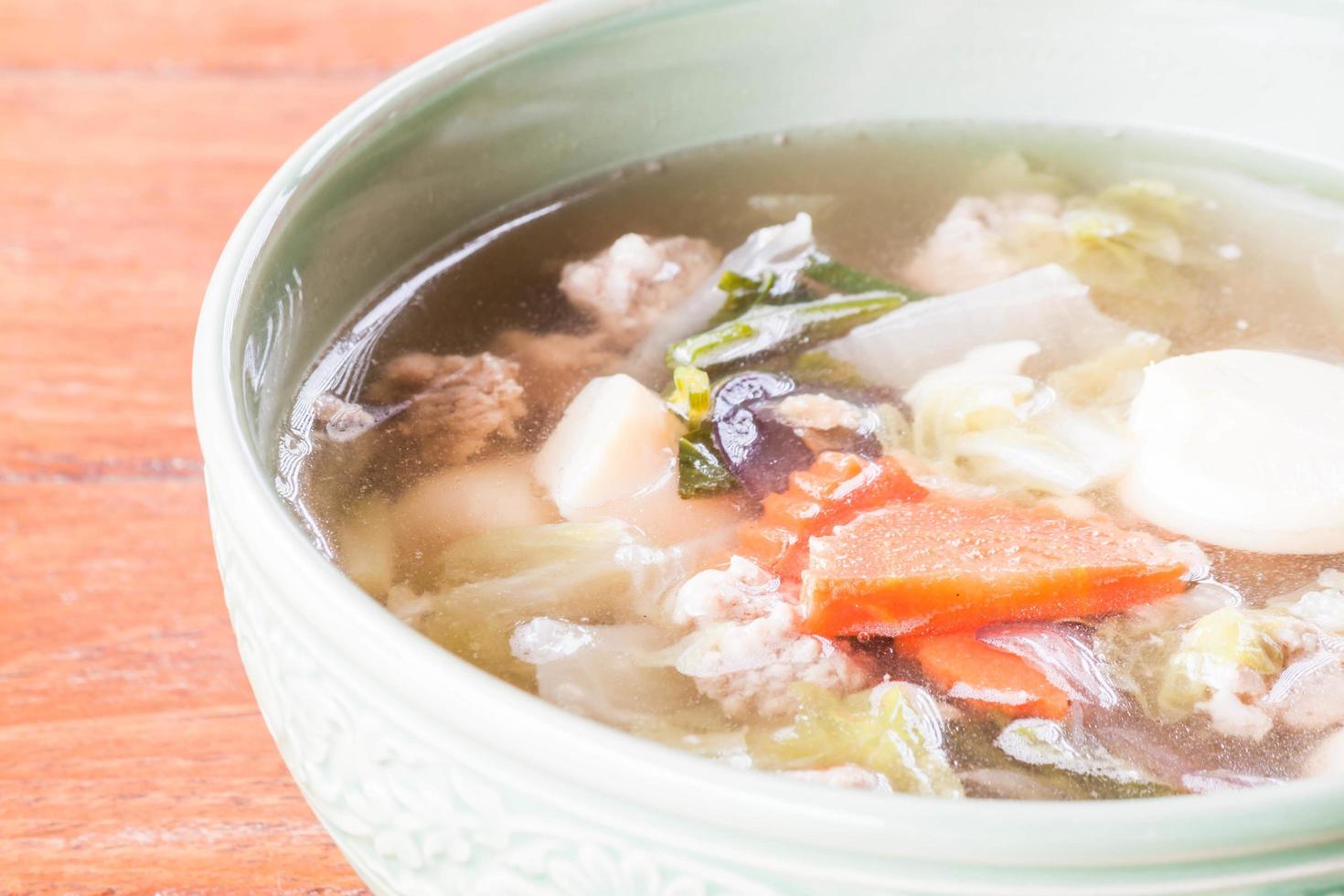 Close-up of a bowl of soup on a table photo