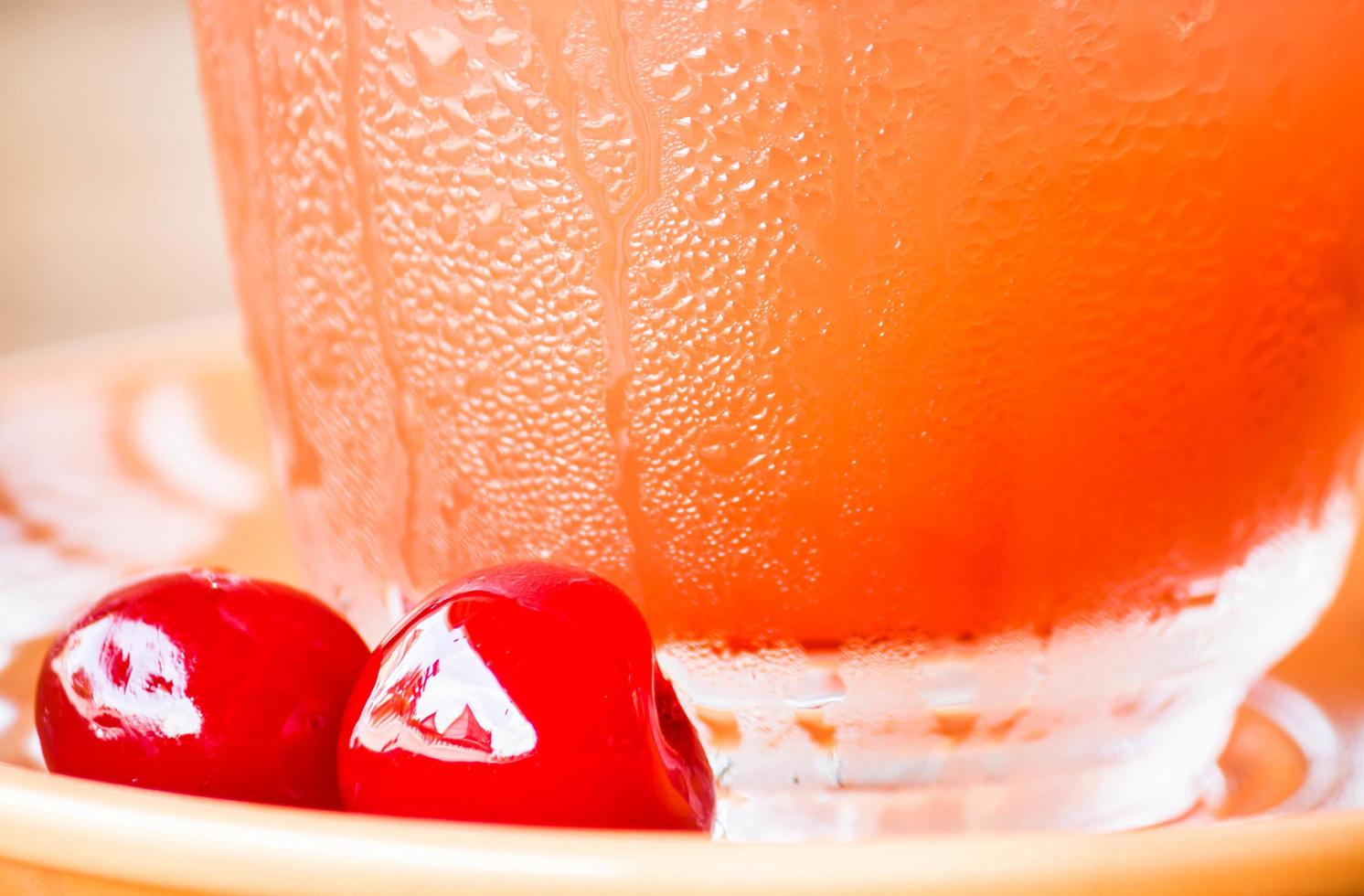 Red cherries near a glass photo