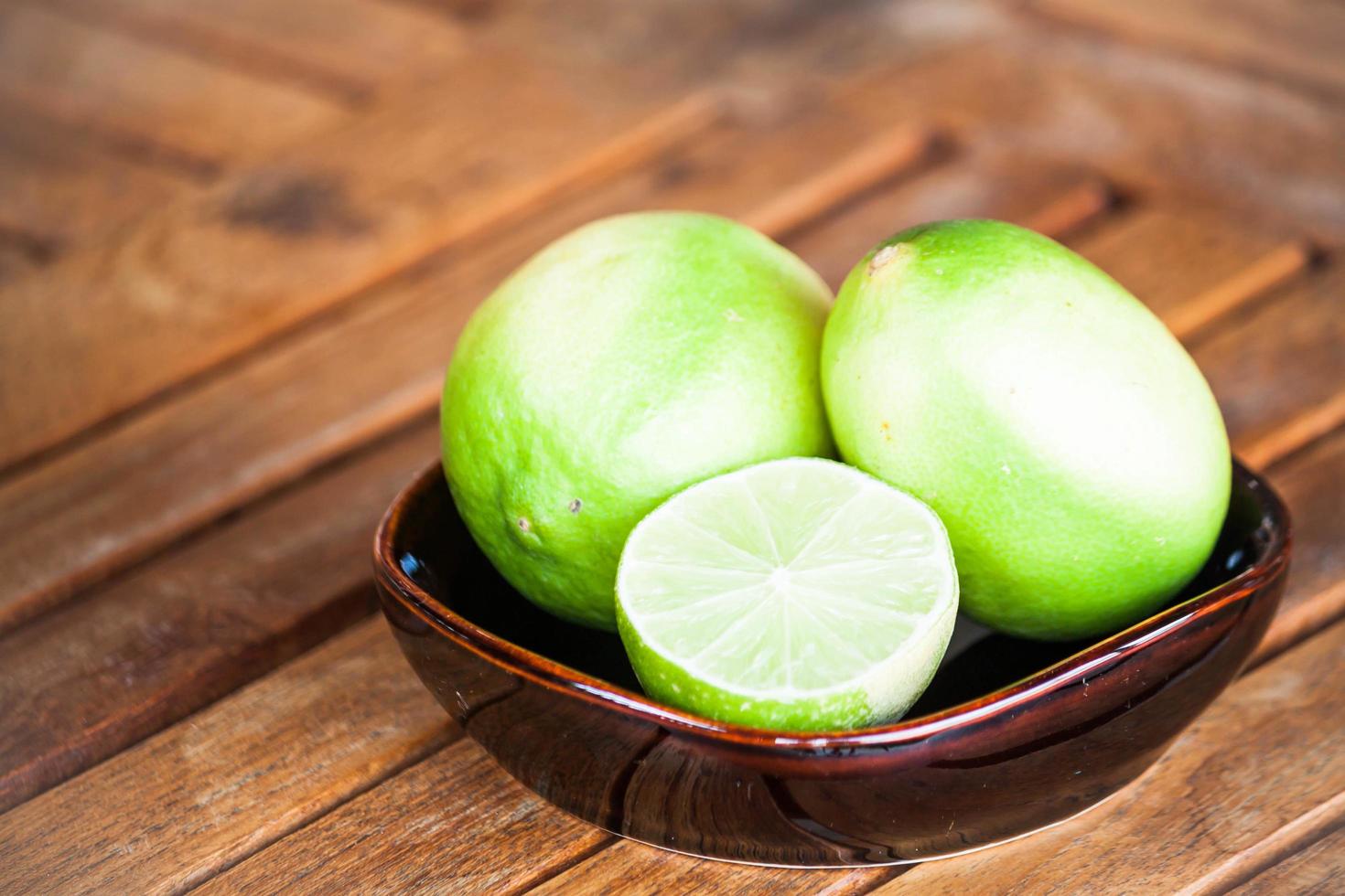 Whole and sliced limes photo