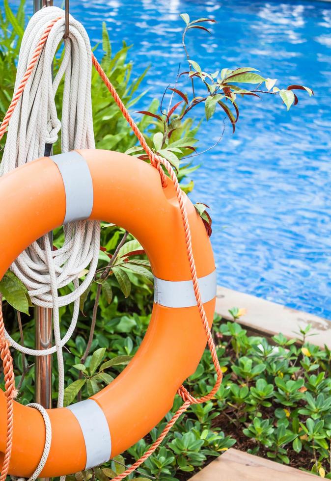 Orange lifebuoy near a swimming pool photo