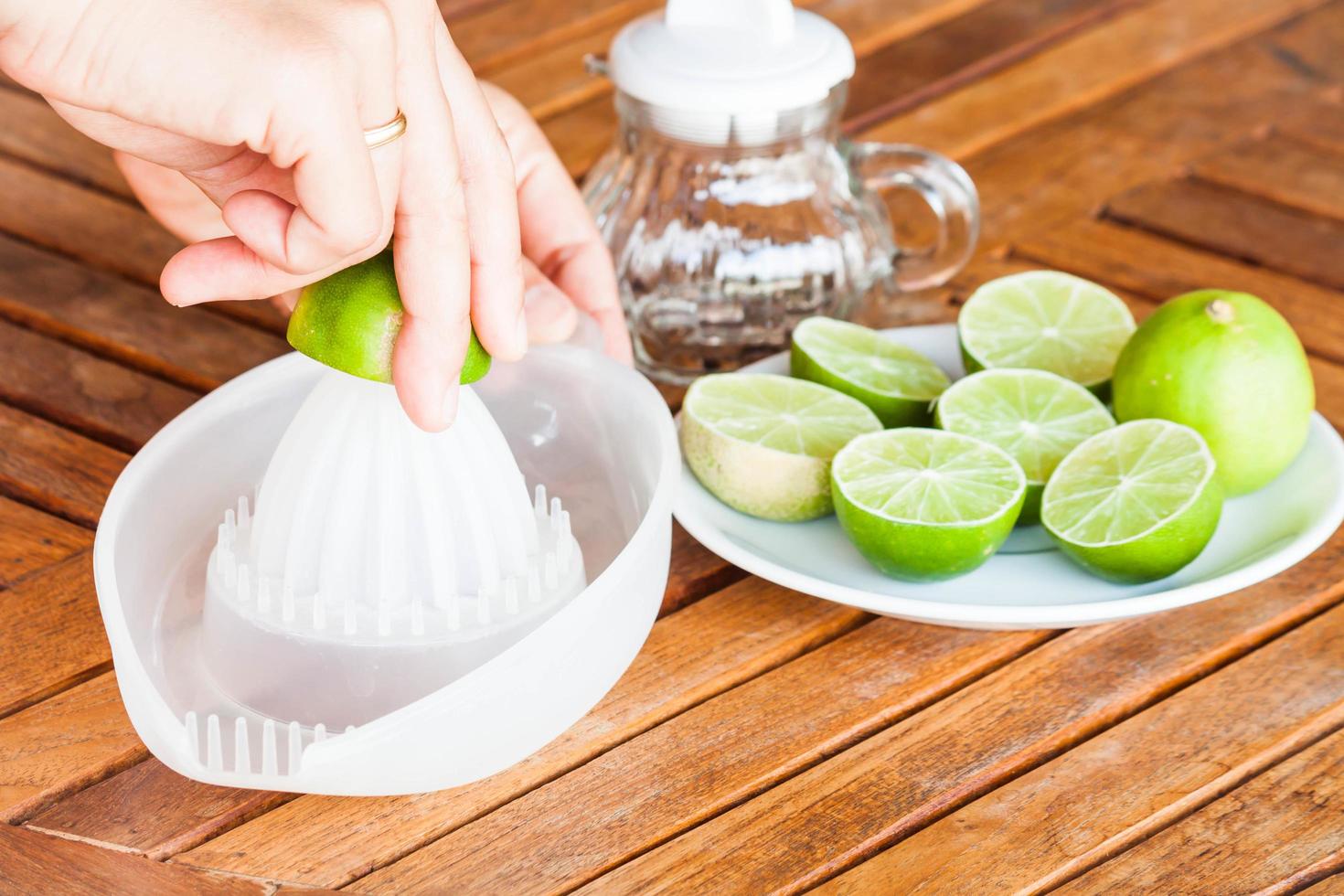 Hand squeezing fresh lime juice photo