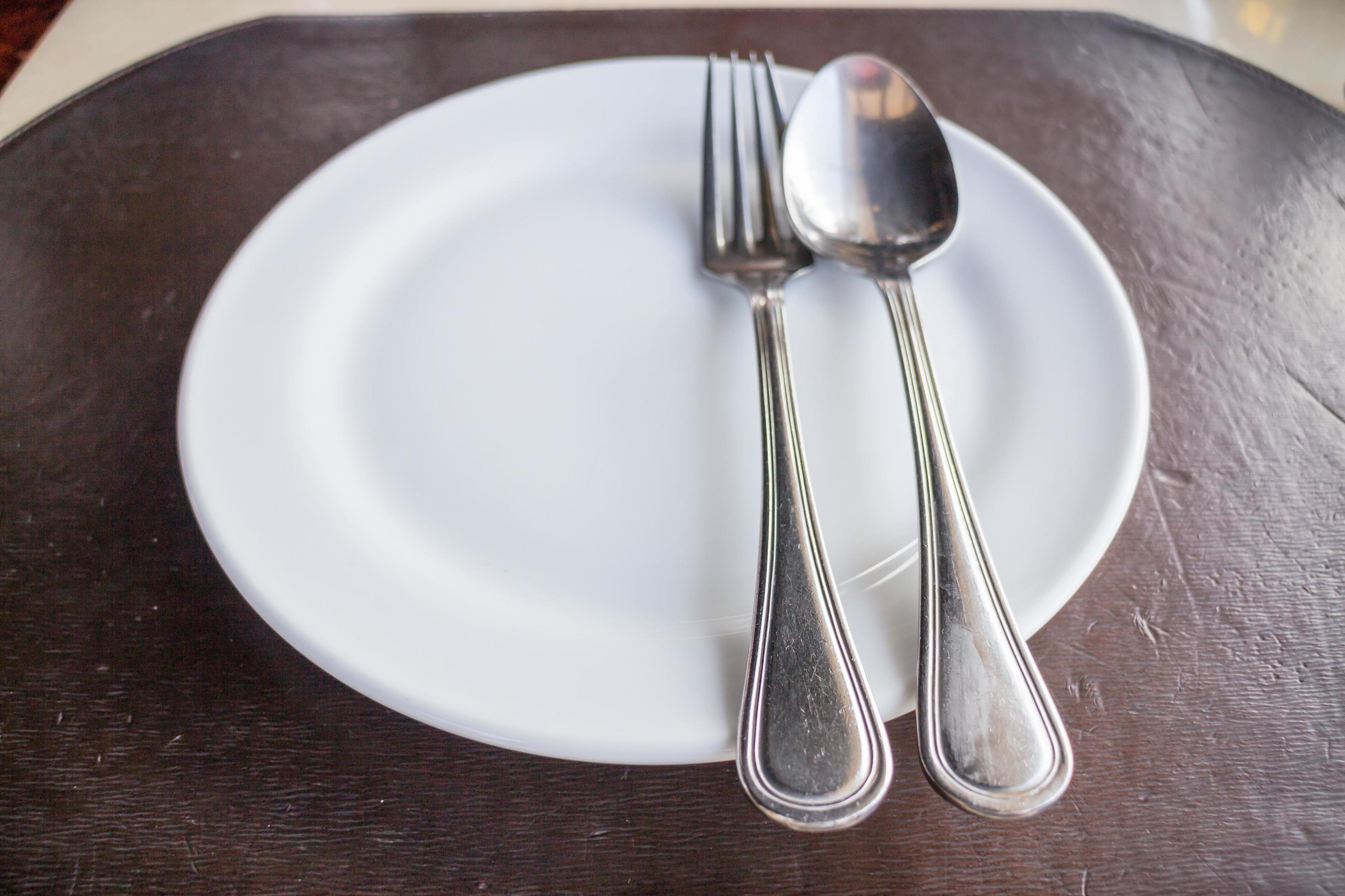 Top View Of A White Plate With A Spoon And A Fork 1740554 Stock Photo top-view-of-a-white-plate-with-a-spoon-and-a-fork-1740554-stock-photo
