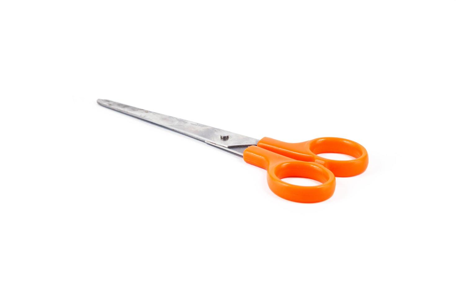 Orange scissors isolated on a white background photo