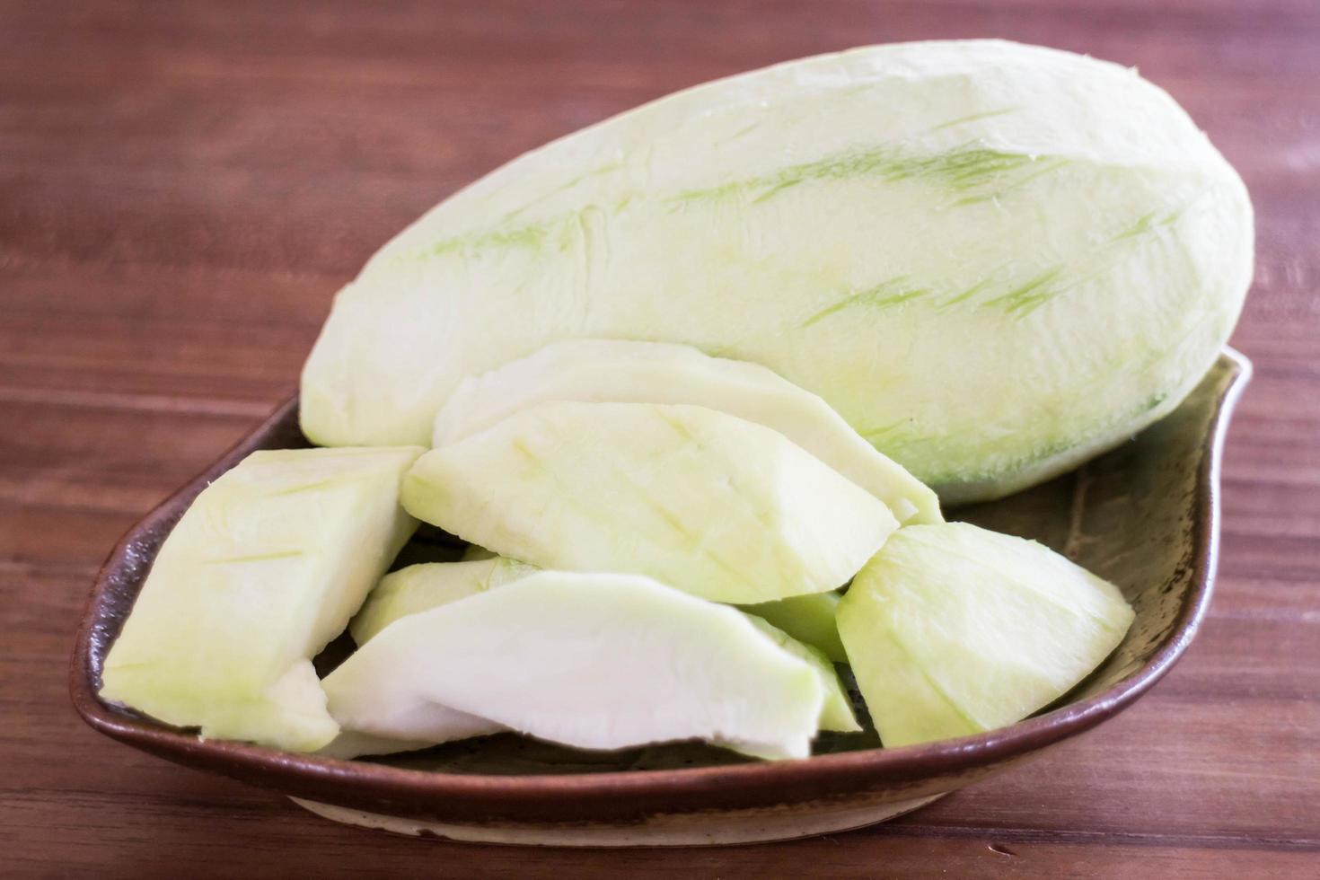 Green mango on a plate photo