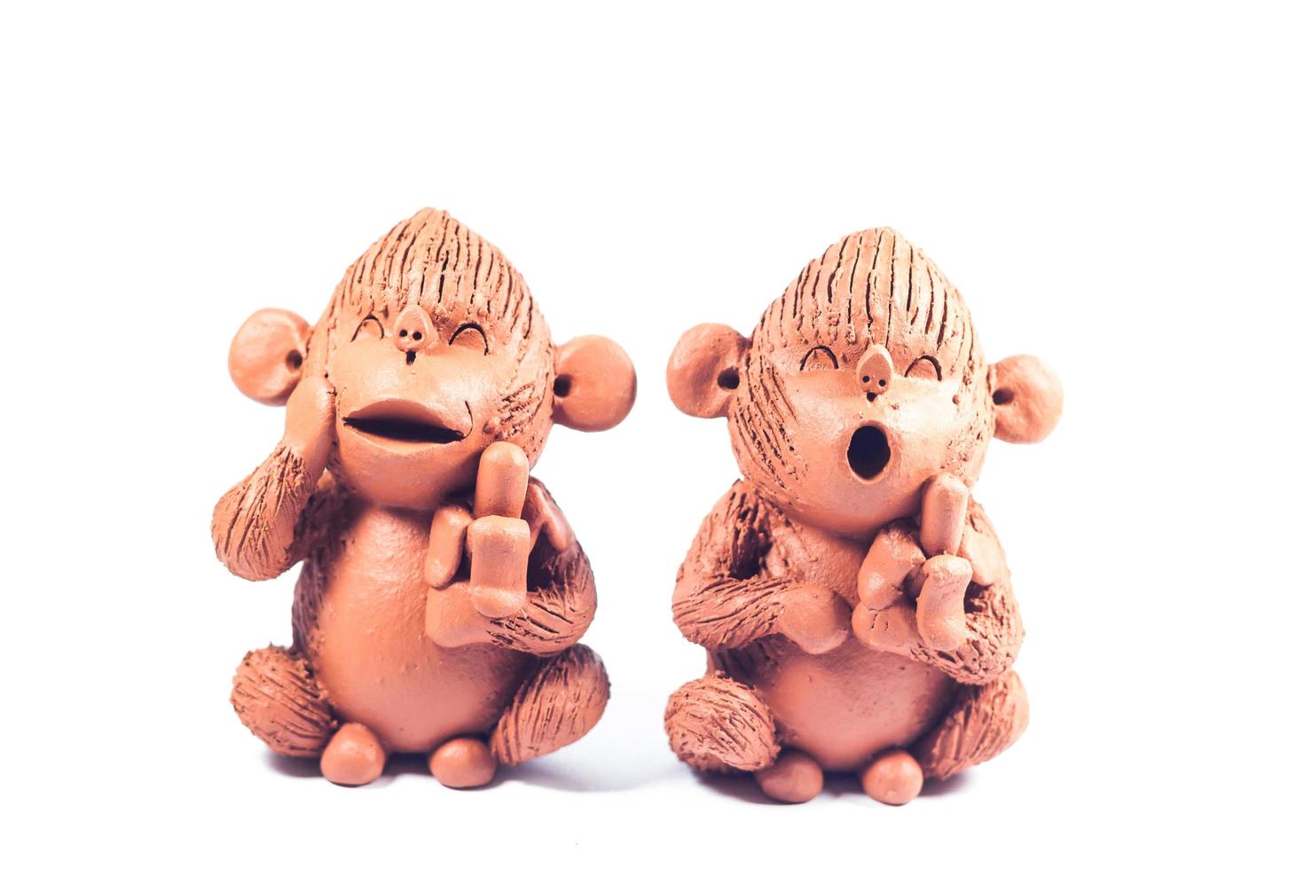 Two clay monkeys on a white background photo