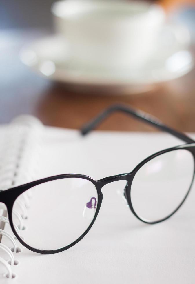 Glasses on a spiral notebook photo