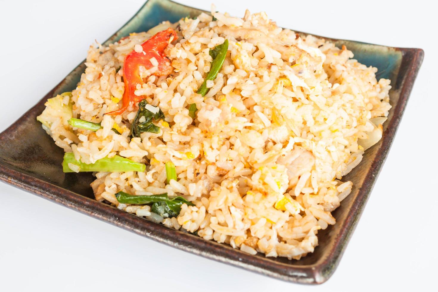 Fried rice with fried pork on a black plate photo