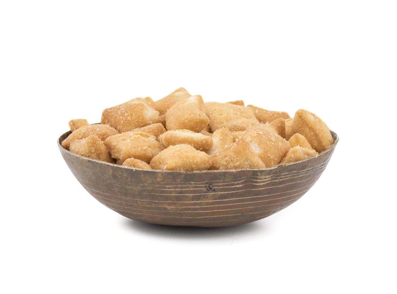 Wooden bowl of shakkarpara snacks photo