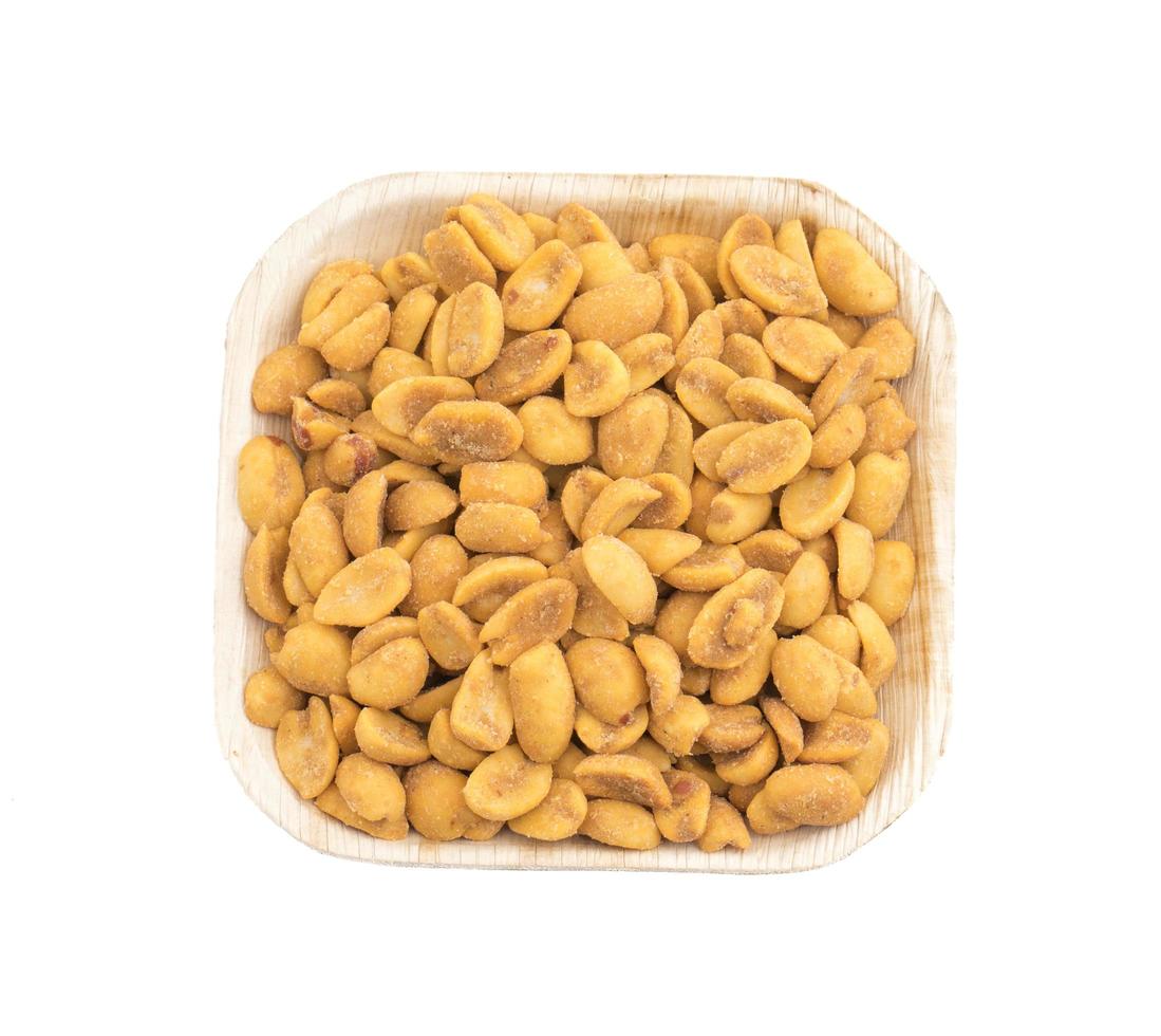 Top view of a white square dish with peanuts photo
