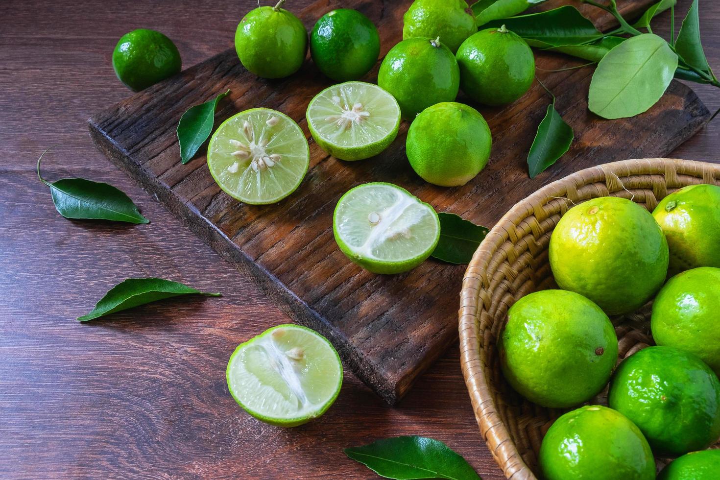 Fresh limes in green basket photo